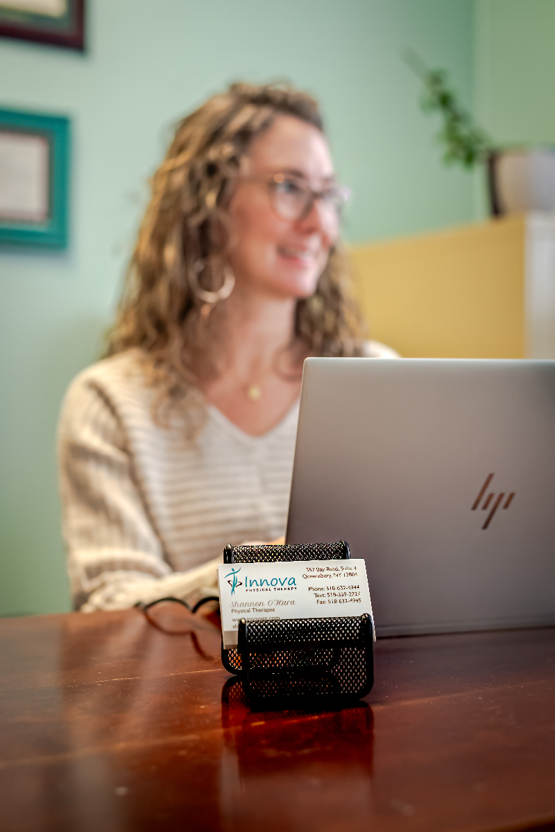 Shannon O'Hara sitting at desk